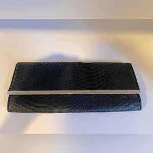 Black faux snake skin style clutch
